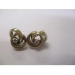 A pair of gold coloured metal double ring design earrings, each set with a diamond