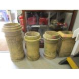 A pair of terracotta chimney pots and two others