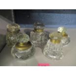 Five mixed early 20th century cut glass inkwells