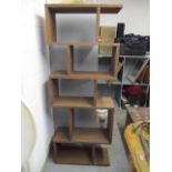 A modern oak finished contemporary display unit 71 1/4"h x 27 1/2"w