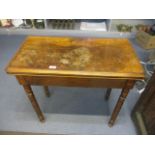 A 19th century walnut card table with a rotating fold over top, on bobbin turned legs