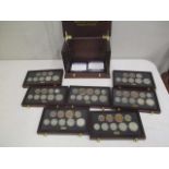 Commemorating WWII, a bespoke coin cabinet containing seven coin sets. One set for each year (1939-