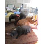 A group of three African carved wooden models of an elephant and two rhinos