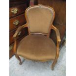 An early/mid 20th century French walnut, button back upholstered armchair