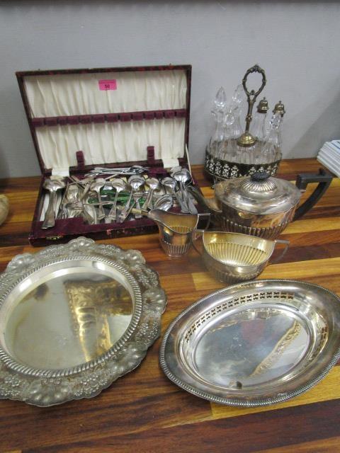 A quantity of silver plated flatware to include a seven bottle silver plated cruet set, bread plates