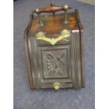 A Victorian mahogany coal scuttle with brass hardware and scoop
