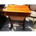 A 19th century mahogany work table having a carved central support and bun shaped feet