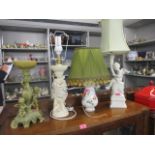A group of four table lamps to include a German floral bone china lamp with vintage green and