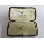 A 9ct yellow and opal set bar brooch, in a M Philcox of London box, total weight, 3.2g