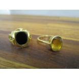 An 18ct yellow gold and citrine ring and a yellow metal gold ring set with a black plaque stone,