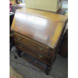 An early 20th century oak bureau having a fall flap and two drawers with bulbous supports, 40"h x 29