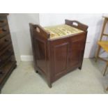 An early 20th century mahogany organ stool