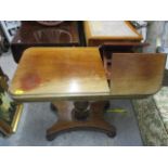 A Victorian mahogany reading table having a quadrofoil base and bun shaped feet, 29" h x 35"w