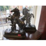 A pair of patinated spelter Marley Horses and figure group
