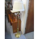 A modern brass standard lamp with a cream shade 61 1/4"h