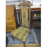 A Victorian prie dieu chair with bobbin turned side, turned front legs with sabre reverse