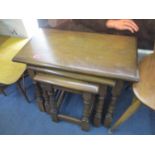 Two Ercol elm two tier lamp tables with drawers and a nest of three tables