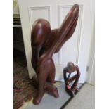 A large African carved figure 33 1/2"h and a matching smaller carving