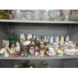 A selection of ceramic ornaments, animals and part tea sets to include Wade, Disney, Belleek,