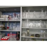 A large selection of glassware to include thirty decanters, lidded bowls, pedestal glasses and other