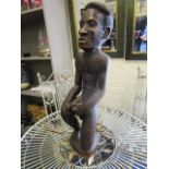 A signed and dated African carved wooden figure of a man circa 1977