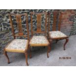 A group of three beech side chairs with carved decoration and drop in seat