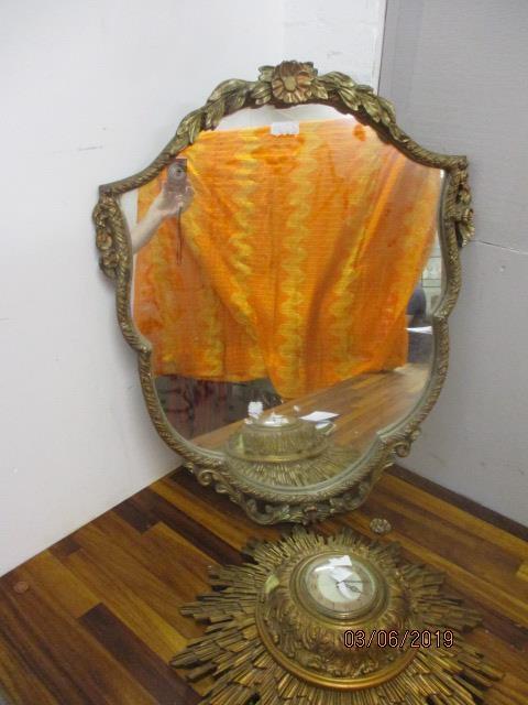 A gilt wall mirror together with an early 20th century sunburst wall clock