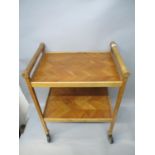 Jack Christmas furniture comprising a walnut two tier tea trolley with turned handles, 28"h, 22"w