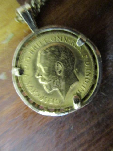 A George V 1914 gold half sovereign set in a 9ct gold setting and on a 9ct gold chain necklace, - Image 3 of 3