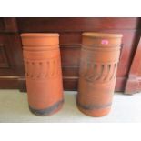 A pair of terracotta chimney pots