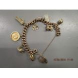 A 9ct gold curb link charm bracelet with a 9ct gold heart shaped catch, having six 9ct gold