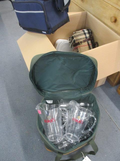 A picnic bag containing outdoor plastic Pimms jugs and glasses, brand new