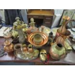 Copper and brassware to include jardinieres, jugs, chargers and other items