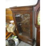 A late 19th century French bookcase with a glazed door over a drawer