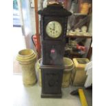 A late Victorian/early 20th century oak cased, longcase clock with key and pendulum