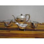 A silver plated three piece tea set and a silver plated sauce boat