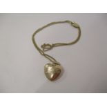 A 9ct yellow gold, heart shaped locket and necklace, 7g