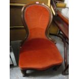 A Victorian mahogany spoon back salon chair having button back upholstery and front fluted legs