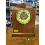 A D Mougin oak cased mantel clock with cream Arabic enamelled dial, the centre with gilt pierced