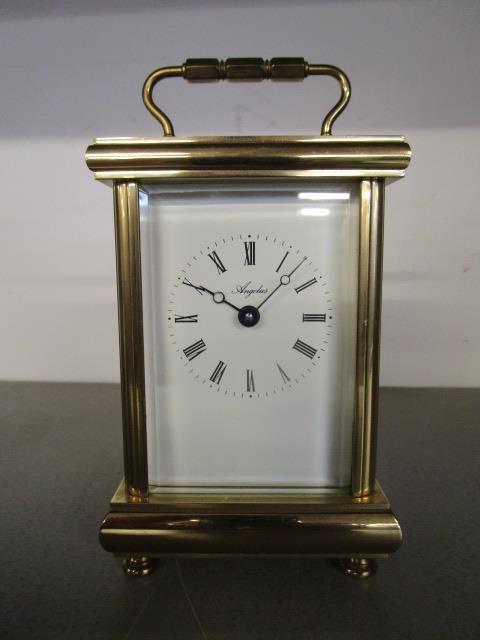 An Angelus key-wound five-window brass carriage clock