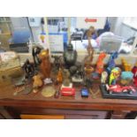 A miscellaneous lot of wooden sculptures, resin elephants, limited edition cats and other items