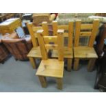 A set of four contemporary light oak dining chairs