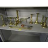 A selection of brass and copper ware to include 18th century brass candlesticks, brass trivets and