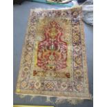 A Middle Eastern style hand woven cotton rug, floral designs, triple guard border and tasselled ends