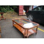 A modern yew wood two-tier glass top coffee table 51"l x 27"w