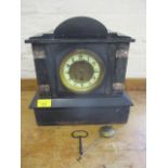 A black slate mantel clock, with key and pendulum