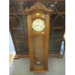 A reproduction Vienna wall clock, with pendulum and weights