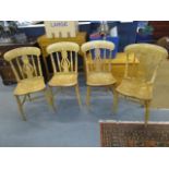 A set of four elm and beech Windsor chairs, pierced centre splat flanked by turned spindles, on ring