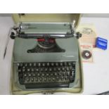 A mid 20th century Olympia typewriter in case