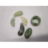 A group of five Chinese jade carved pendants and a green jade ring, early 21st century